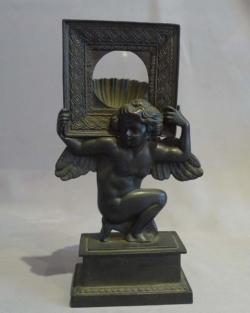 Antique Russian cast iron neo classical watchstand of cupid.