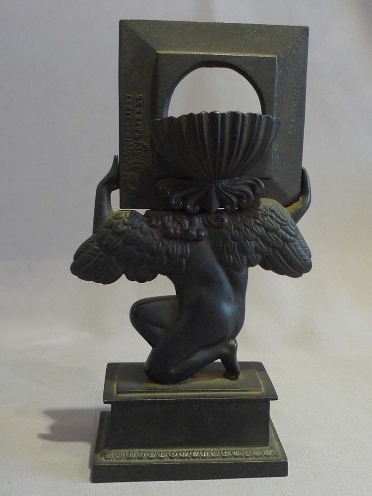 Antique Russian cast iron neo classical watchstand of cupid.