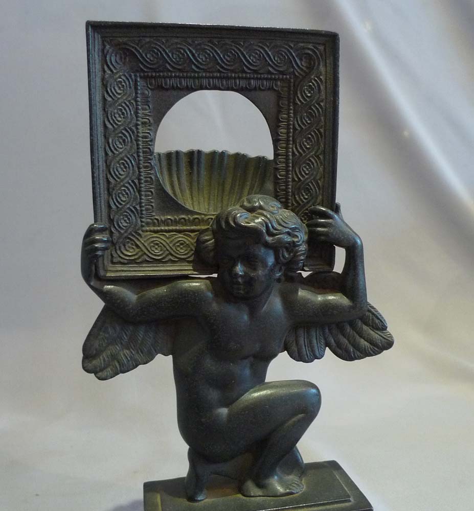 Antique Russian cast iron neo classical watchstand of cupid.