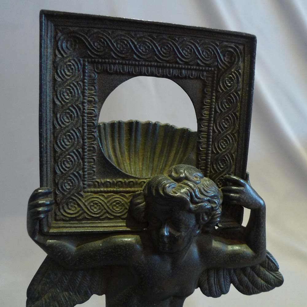 Antique Russian cast iron neo classical watchstand of cupid.