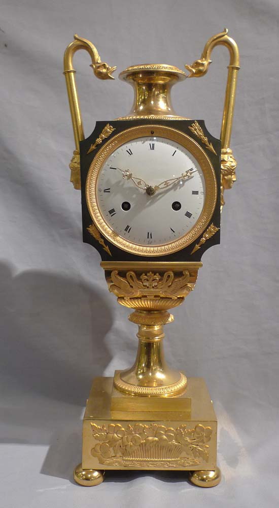 Antique French Empire vase shaped mantel clock in ormolu and patinated bronze