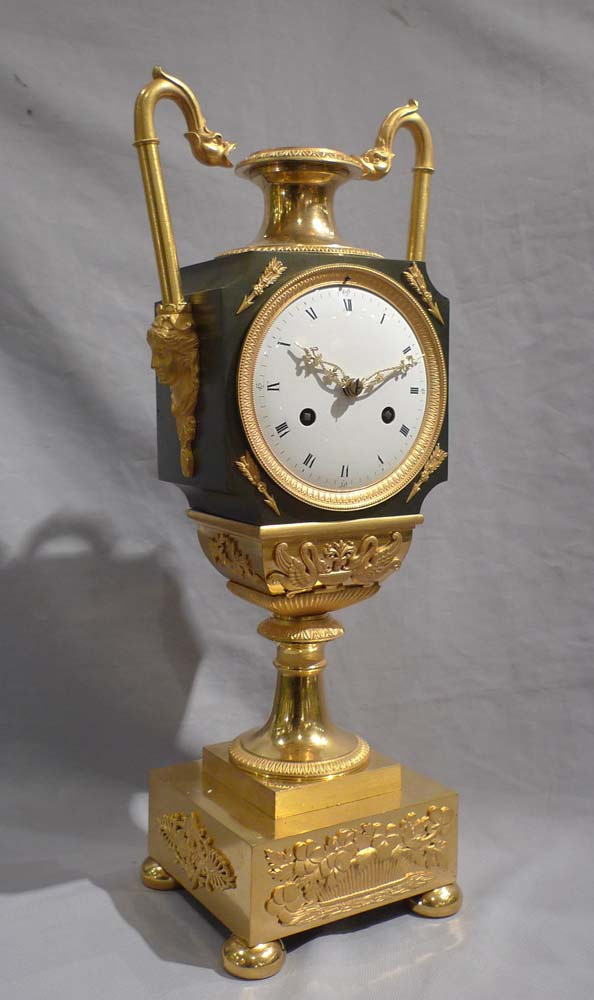 Antique French Empire vase shaped mantel clock in ormolu and patinated bronze