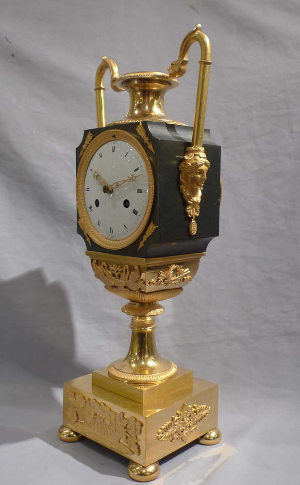 Antique French Empire vase shaped mantel clock in ormolu and patinated bronze