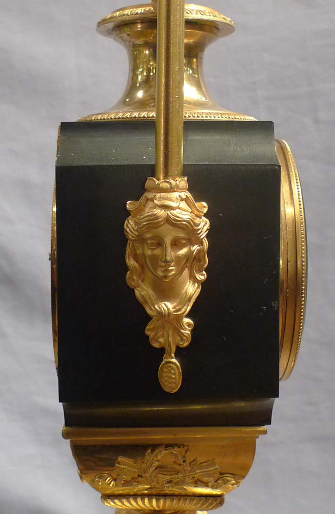 Antique French Empire vase shaped mantel clock in ormolu and patinated bronze