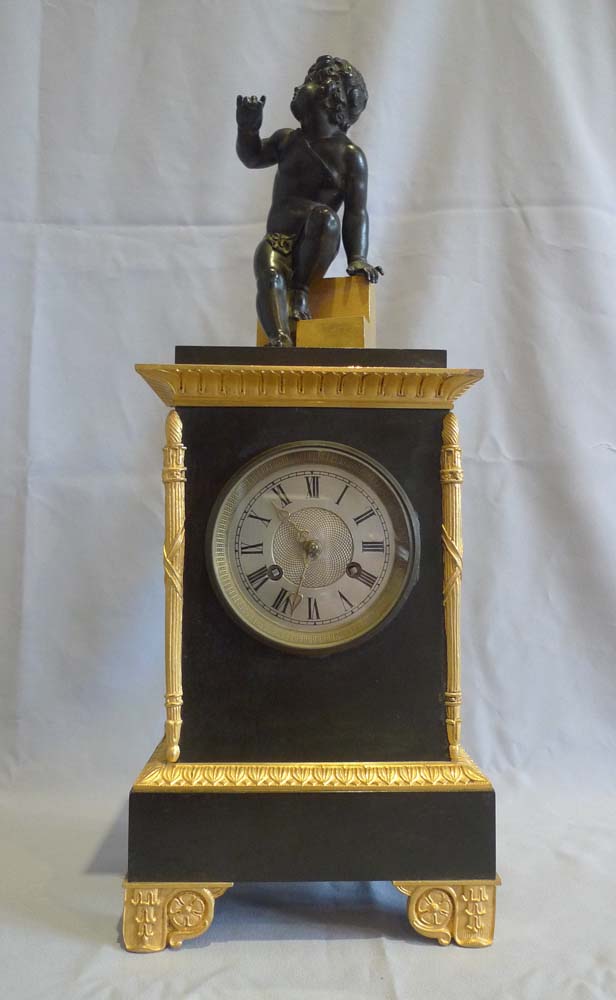 Antique Charles X mantel clock in patinated bronze and ormolu.