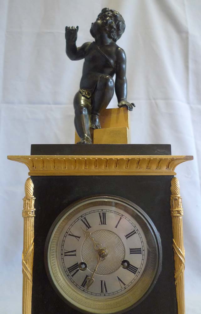 Antique Charles X mantel clock in patinated bronze and ormolu.