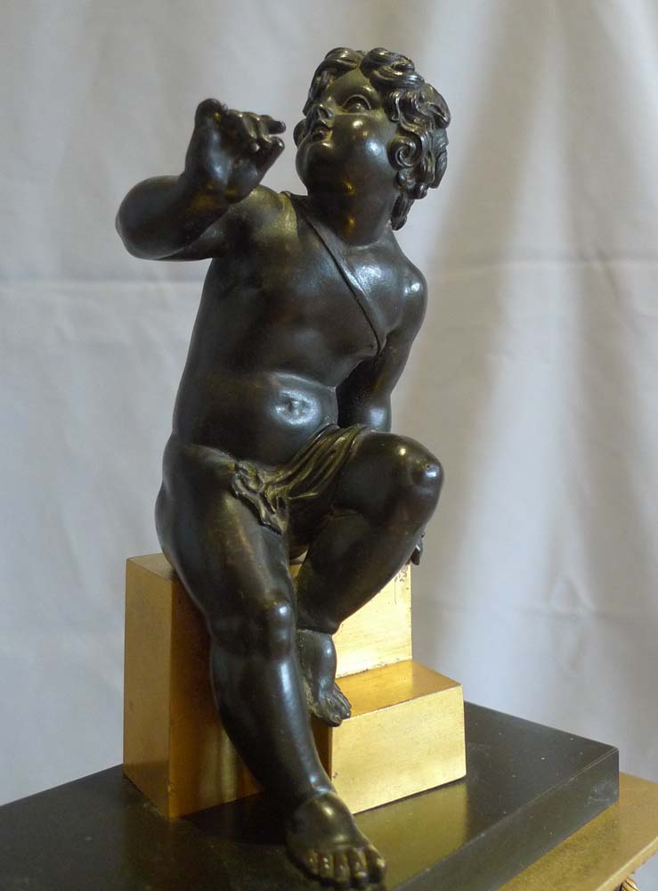 Antique Charles X mantel clock in patinated bronze and ormolu.