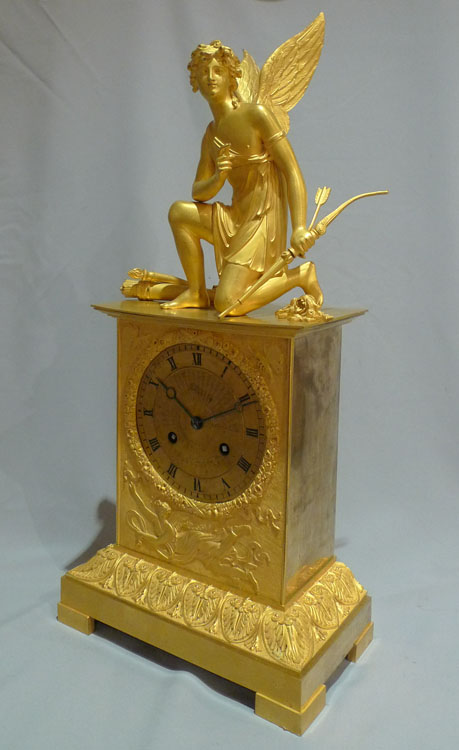 Antique French ormolu mantel clock of Charles X period of a kneeling Cupid.