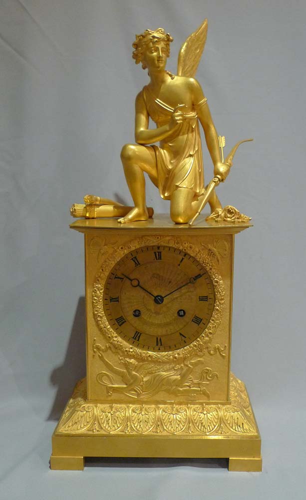Antique French ormolu mantel clock of Charles X period of a kneeling Cupid.