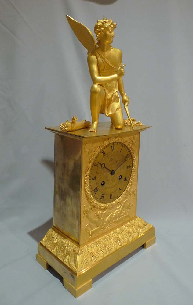 Antique French ormolu mantel clock of Charles X period of a kneeling Cupid.