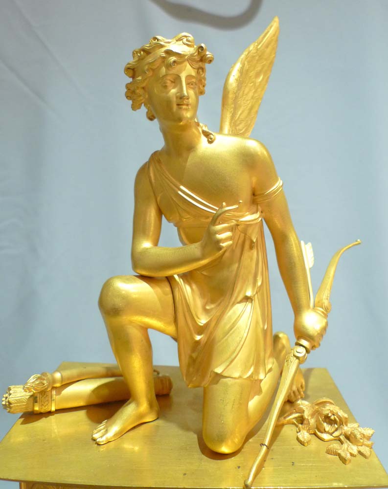 Antique French ormolu mantel clock of Charles X period of a kneeling Cupid.