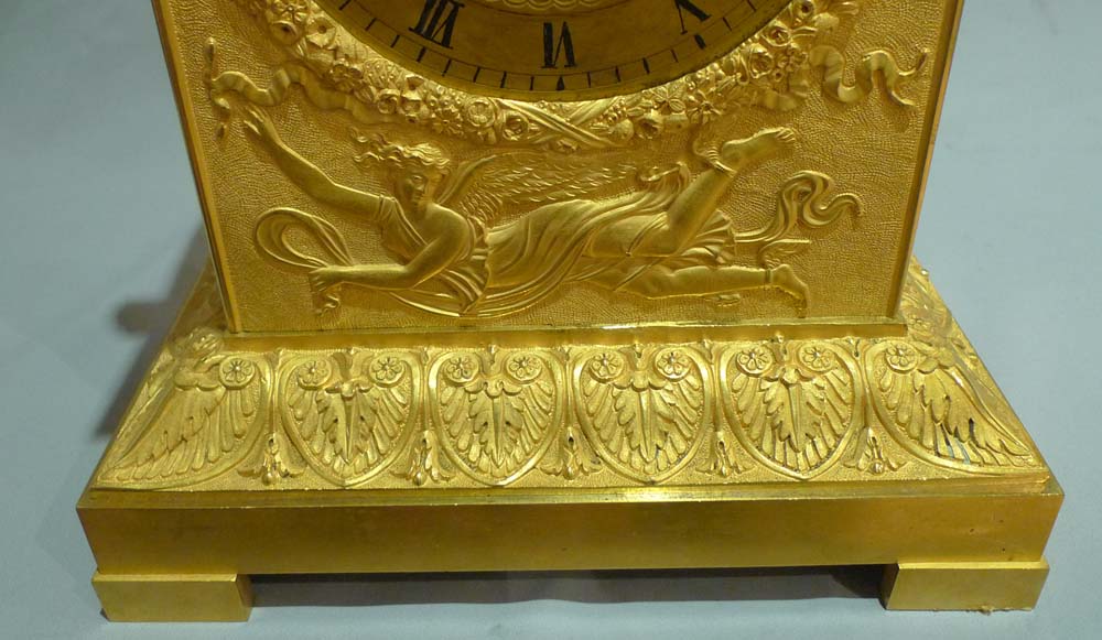 Antique French ormolu mantel clock of Charles X period of a kneeling Cupid.
