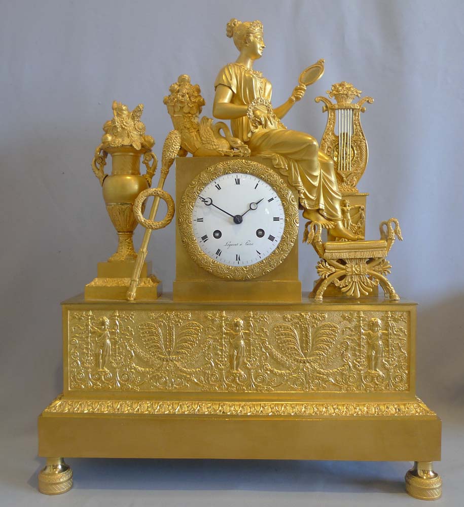 French Empire ormolu mantel clock depicting vanity?.