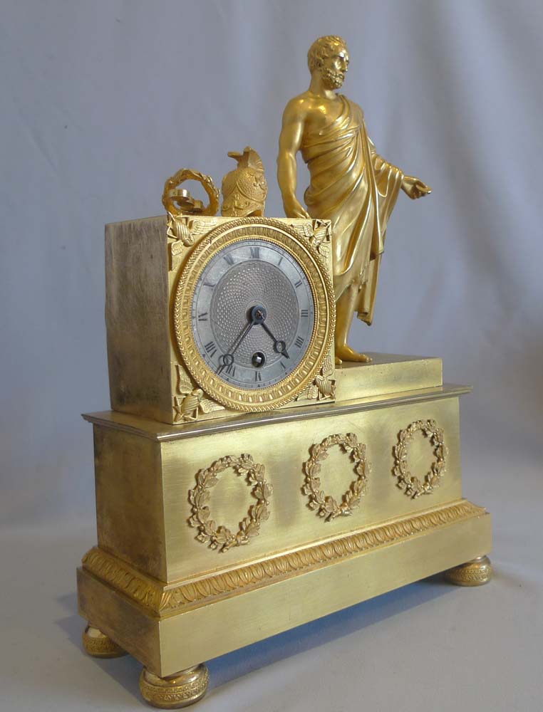 Antique French Empire ormolu mantel clock of Roman with coins.