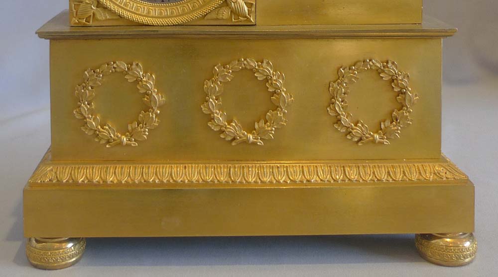 Antique French Empire ormolu mantel clock of Roman with coins.