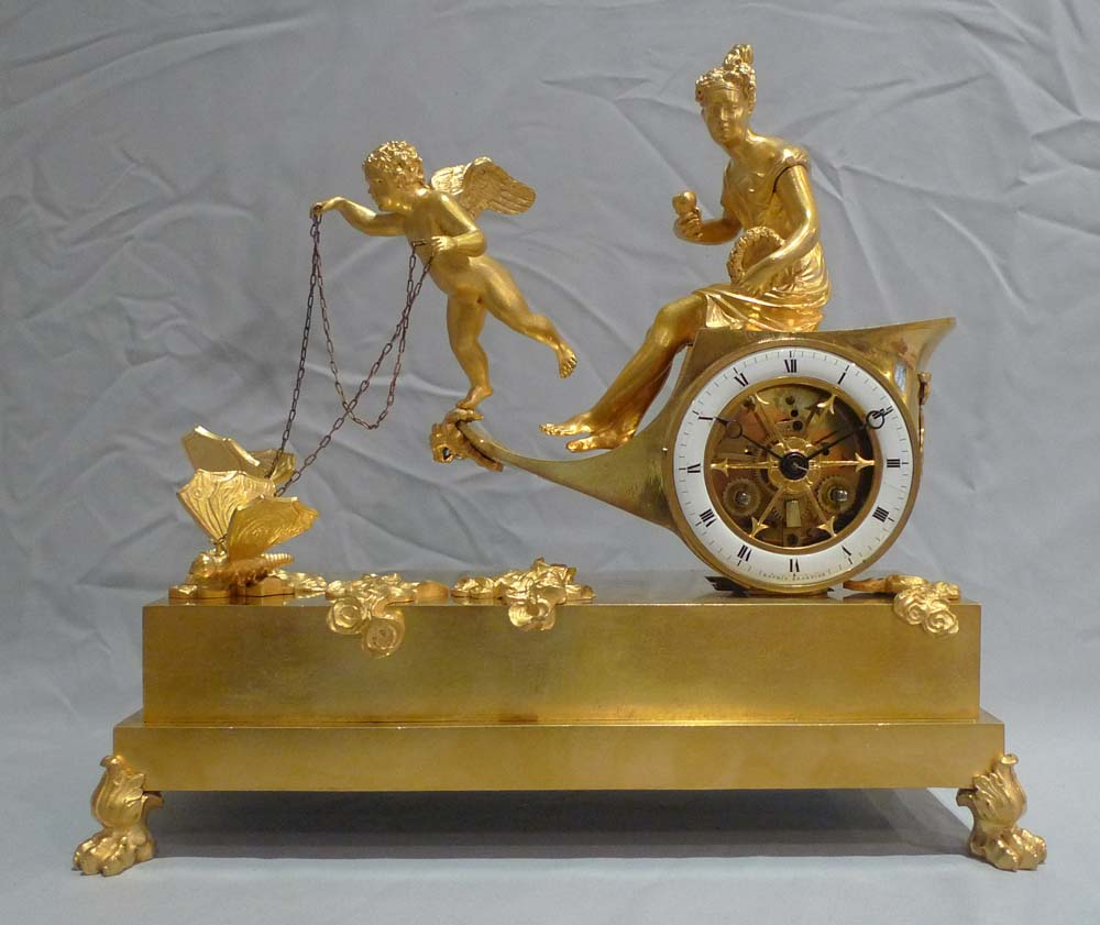 Antique French Empire chariot clock in ormolu signed Ravrio.