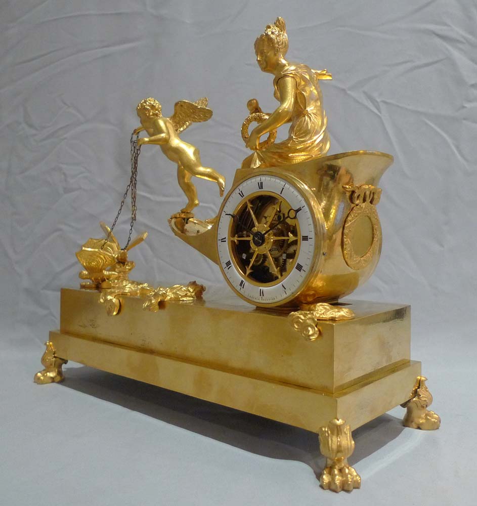 Antique French Empire chariot clock in ormolu signed Ravrio.