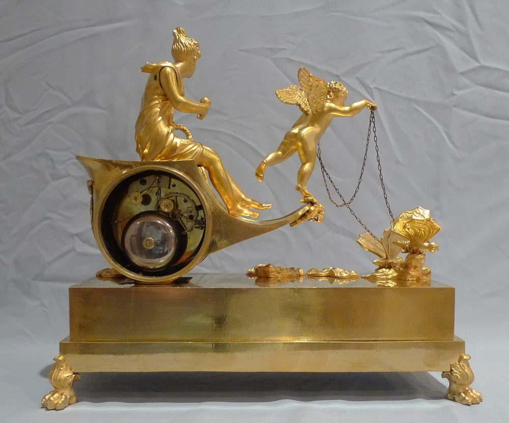 Antique French Empire chariot clock in ormolu signed Ravrio.