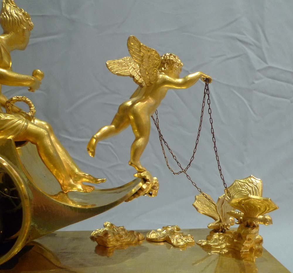 Antique French Empire chariot clock in ormolu signed Ravrio.