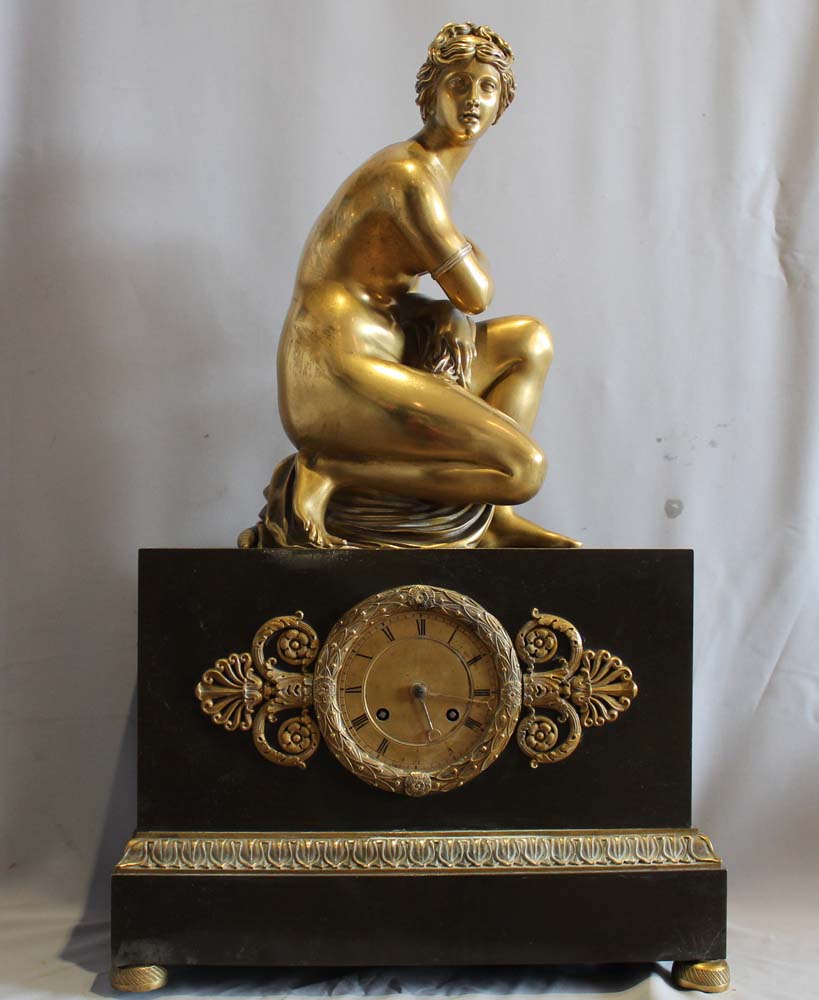 French Charles X mantel clock with Grand Tour Crouching Venus, patinated bronze and ormolu.