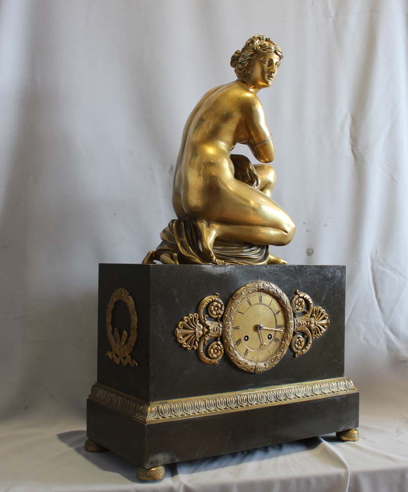 French Charles X mantel clock with Grand Tour Crouching Venus, patinated bronze and ormolu.