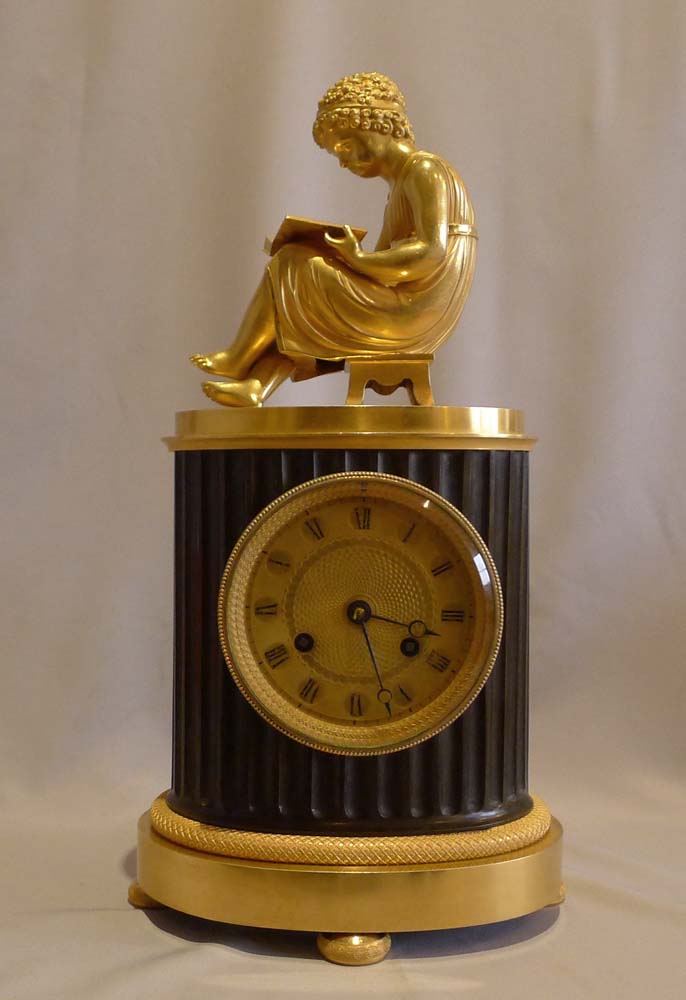 Antique French Empire library clock of a child reading..
