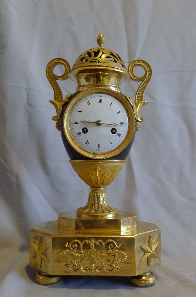 Antique French Empire patinated bronze and ormolu vase clock dated 1810.