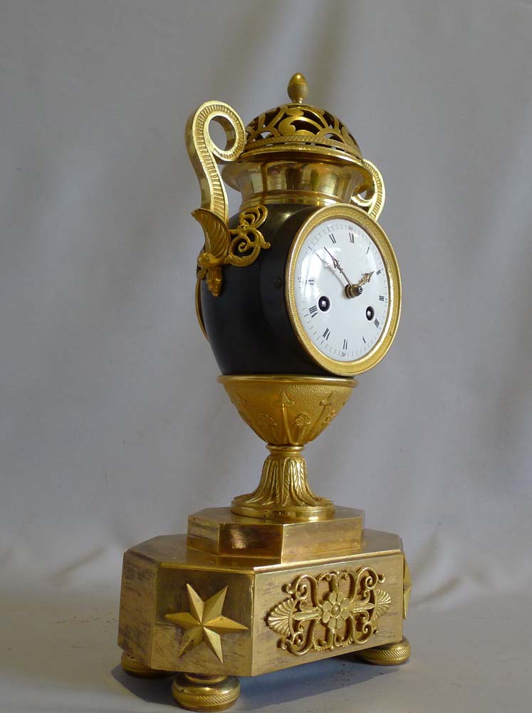 Antique French Empire patinated bronze and ormolu vase clock dated 1810.