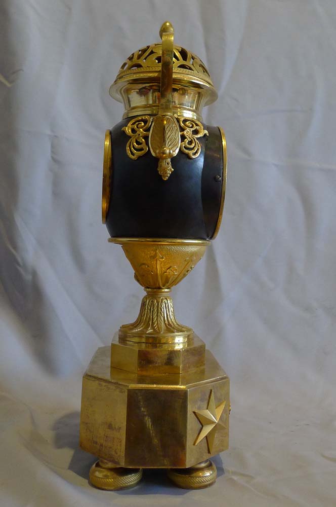 Antique French Empire patinated bronze and ormolu vase clock dated 1810.