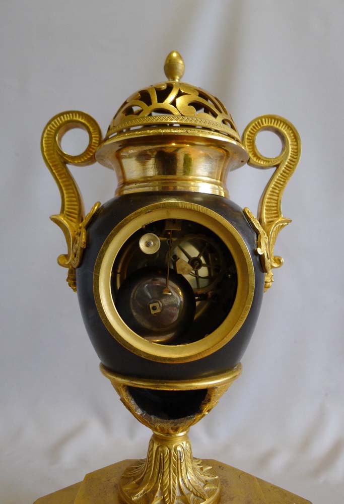 Antique French Empire patinated bronze and ormolu vase clock dated 1810.