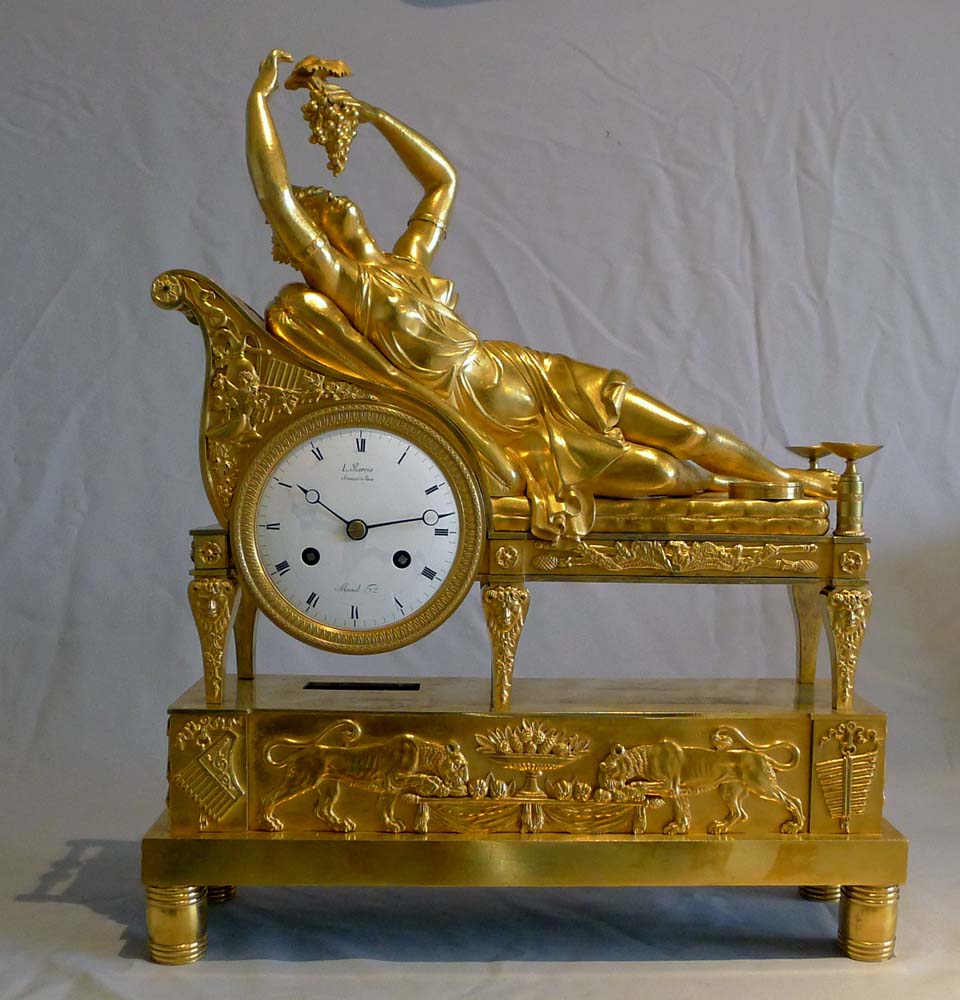 Antique French Empire clock of a Bacchante lying on her day bed.