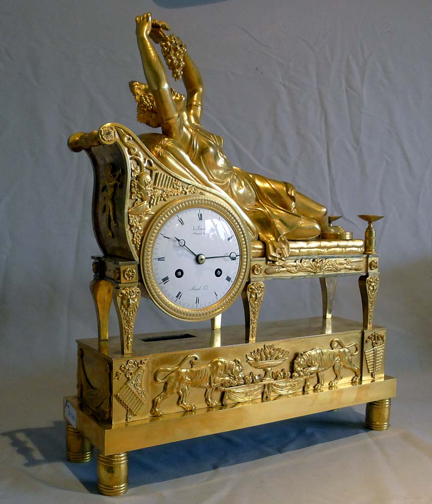 Antique French Empire clock of a Bacchante lying on her day bed.