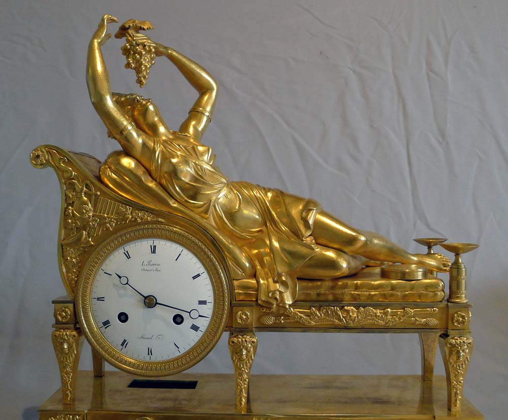 Antique French Empire clock of a Bacchante lying on her day bed.