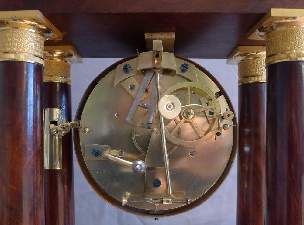 Antique French Empire period, flame mahogany and ormolu mounted musical portico clock.