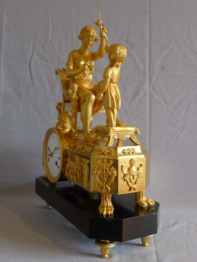 Fine French Empire clock of woman playing with child in ormolu and black marble.