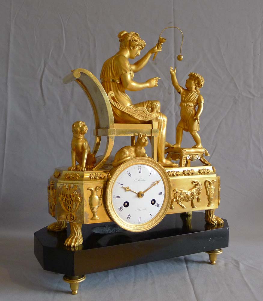 Fine French Empire clock of woman playing with child in ormolu and black marble.