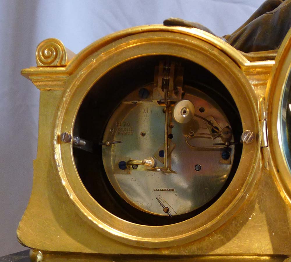 Antique French mantel clock in ormolu, black marble and patinated bronze of woman reading.