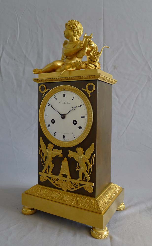 Beautiful French Empire ormolu and patinated bronze clock of Cupid  signed Louis Mallet.
