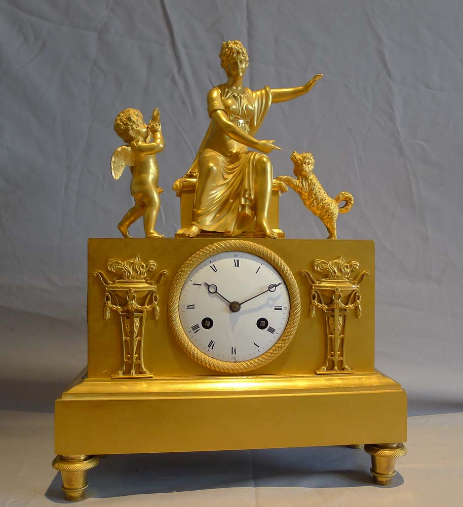 Antique ormolu French Empire mantel clock of woman playing with dog.