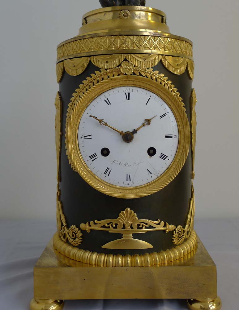 Antique French Ist Empire clock in patinated bronze and ormolu of cupid playing a drum.