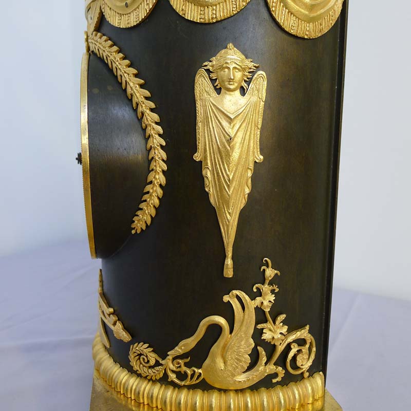 Antique French Ist Empire clock in patinated bronze and ormolu of cupid playing a drum.