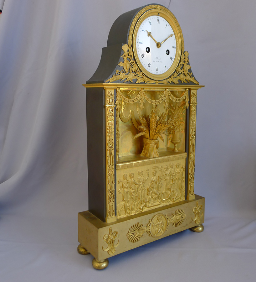 Antique French Empire mantel clock in ormolu and patinated bronze signed  Revel Rue De Richelieu