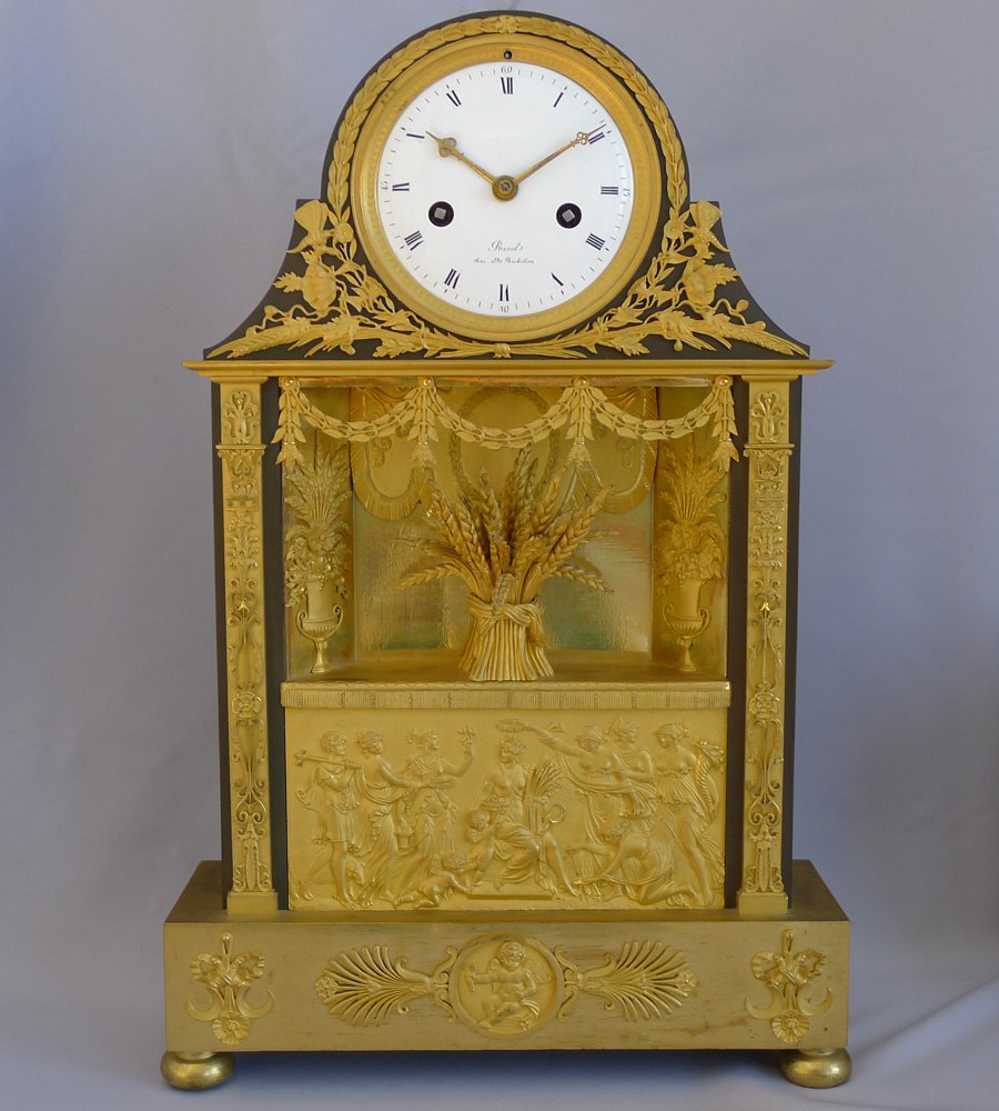 Antique French Empire mantel clock in ormolu and patinated bronze signed  Revel Rue De Richelieu