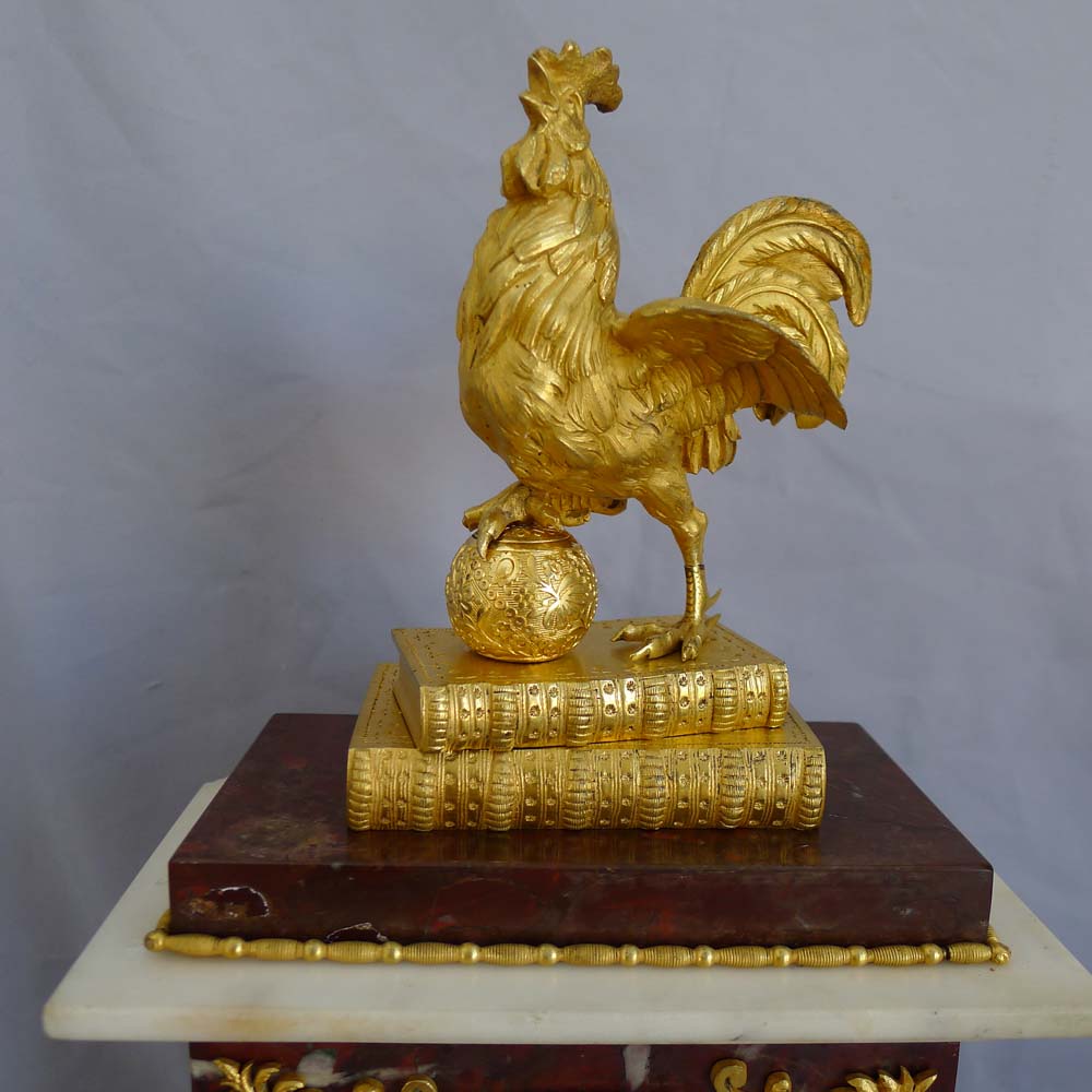 Antique French Directoire mantel clock by Gaston Jolly with Frenchcockerel standing on books.