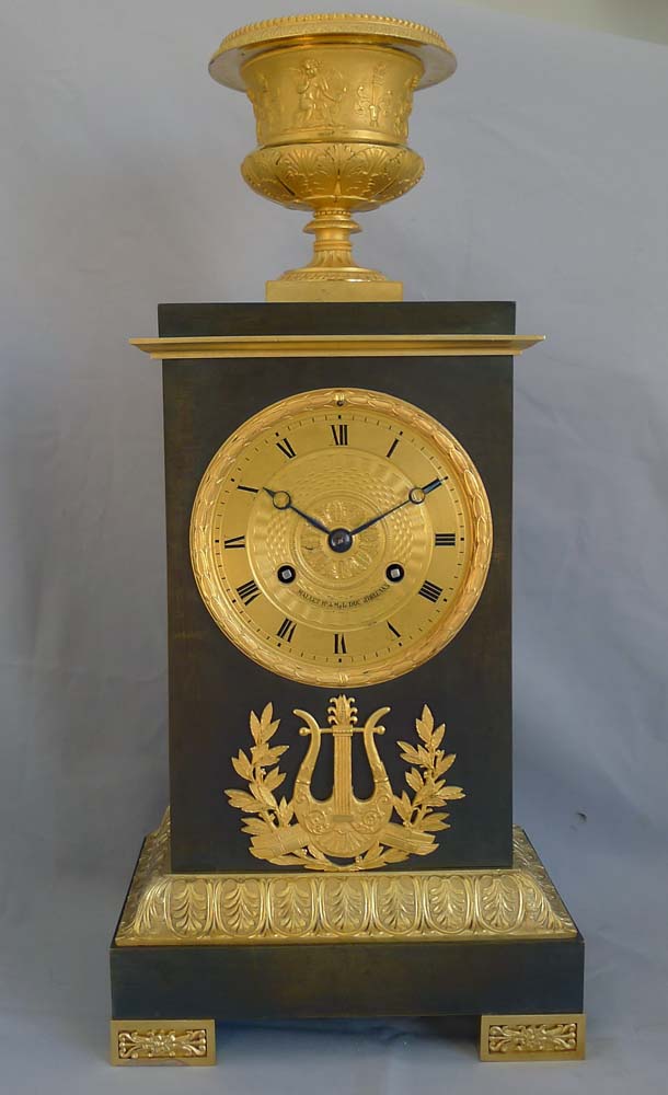 Antique French Charles X period mantel clock in ormolu and patinated bronze