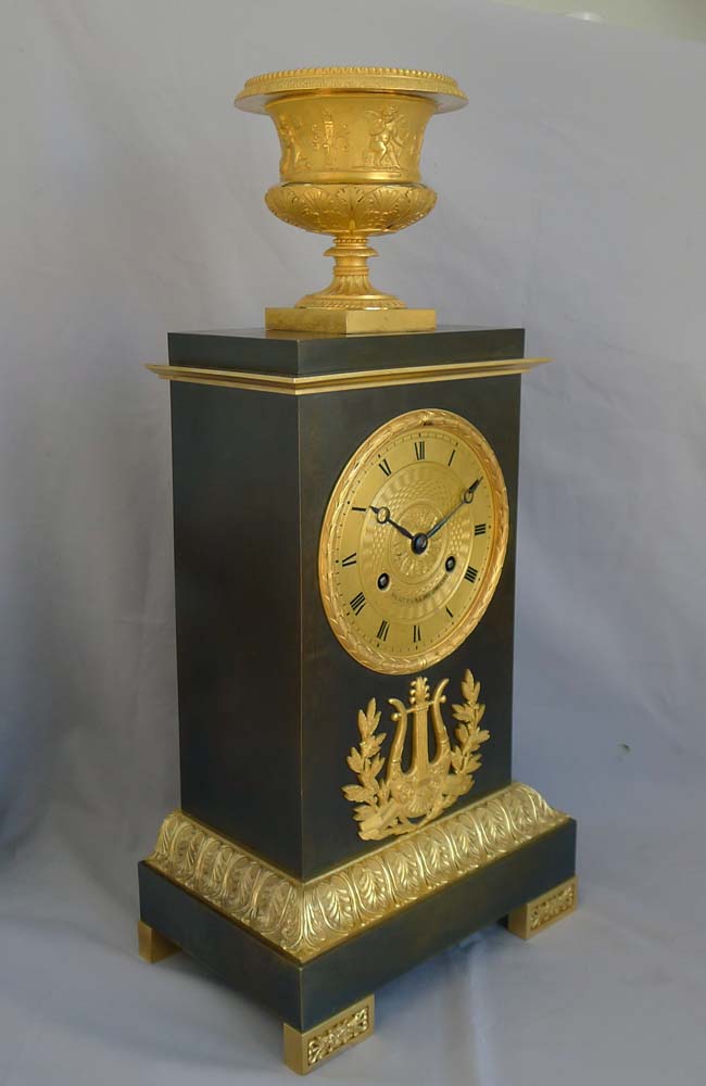 Antique French Charles X period mantel clock in ormolu and patinated bronze