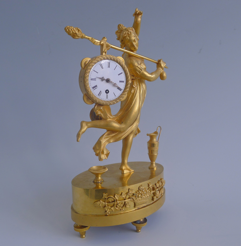 Antique French Empire miniature mantel clock of a dancing bacchante in ormolu
