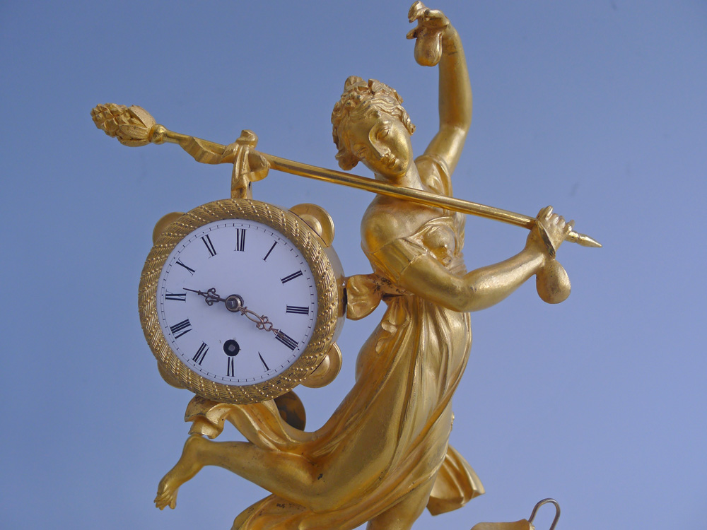 Antique French Empire miniature mantel clock of a dancing bacchante in ormolu