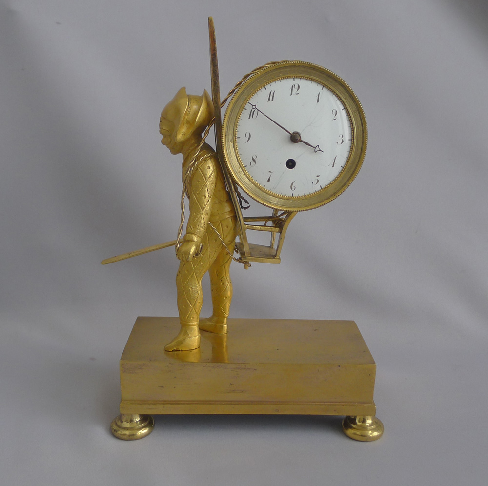 French Empire antique Ormolu clock of Harlequin as a street porter carrying time