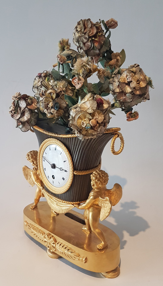 French Empire Ormolu and Patinated Bronze Clock of Amorettis holding up Basket Flowers